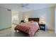 A bedroom with a ceiling fan, tile floors, and a view into the bathroom at 8138 E Via De La Escuela --, Scottsdale, AZ 85258