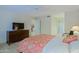 Comfortable bedroom features a wooden dresser, ceiling fan, and a glimpse into other rooms at 8138 E Via De La Escuela --, Scottsdale, AZ 85258