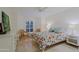Bright bedroom features a colorful quilt, wicker chairs, and tile floors at 8138 E Via De La Escuela --, Scottsdale, AZ 85258