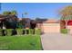 Charming single-story home with desert landscaping, tile roof, and attached two-car garage at 8138 E Via De La Escuela --, Scottsdale, AZ 85258