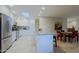Bright kitchen with skylight, white cabinetry, stainless appliances, and island open to dining area at 8138 E Via De La Escuela --, Scottsdale, AZ 85258