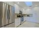 Modern kitchen with stainless appliances, granite counters, white cabinets and a bright skylight at 8138 E Via De La Escuela --, Scottsdale, AZ 85258