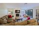 Cozy living room featuring a fireplace, large sofa, and access to the outdoor patio at 8138 E Via De La Escuela --, Scottsdale, AZ 85258