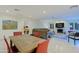 Bright, open living room with fireplace, TV, and comfortable seating adjacent to the dining area at 8138 E Via De La Escuela --, Scottsdale, AZ 85258