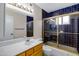 This full bathroom features stylish blue tile in the shower and around the shower and a large vanity at 829 S Revolta Cir, Mesa, AZ 85208