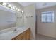 Bathroom featuring a modern sink and vanity, large mirror and walk in shower at 829 S Revolta Cir, Mesa, AZ 85208