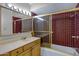 Cozy bathroom with wood vanity, tiled shower/tub combo and a large mirror at 829 S Revolta Cir, Mesa, AZ 85208