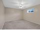Neutral bedroom showcasing carpet, ceiling fan, and window with natural light at 829 S Revolta Cir, Mesa, AZ 85208