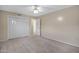 Neutral bedroom showcasing carpet, ceiling fan, and a large closet at 829 S Revolta Cir, Mesa, AZ 85208