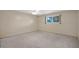 Neutral bedroom showcasing carpet, ceiling fan, and window with natural light at 829 S Revolta Cir, Mesa, AZ 85208
