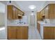 Functional kitchen with wood cabinets and an efficient layout at 829 S Revolta Cir, Mesa, AZ 85208