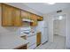Close-up of the bright kitchen featuring white appliances and light countertops at 829 S Revolta Cir, Mesa, AZ 85208