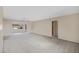 Spacious carpeted living room with a ceiling fan and bright natural light at 829 S Revolta Cir, Mesa, AZ 85208