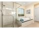 Bathroom featuring a glass shower, soaking tub and a neutral color palette at 834 E Kachina Trl, Phoenix, AZ 85042