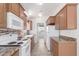 Functional kitchen with white appliances, wooden cabinets, and granite countertops at 8865 E Baseline Rd # 1731, Mesa, AZ 85209