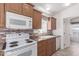 Close up of the kitchen featuring white appliances, wood cabinets and granite countertops at 8865 E Baseline Rd # 1731, Mesa, AZ 85209
