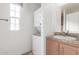 Bright laundry room with stacked washer and dryer and sink with vanity at 8865 E Baseline Rd # 1731, Mesa, AZ 85209