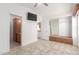 Spacious main bedroom with closet space, TV and view into bathroom and kitchen at 8865 E Baseline Rd # 1731, Mesa, AZ 85209