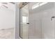 Shower with glass door and white tile surround, view into main bedroom at 8865 E Baseline Rd # 1731, Mesa, AZ 85209