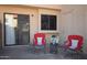 Cozy patio setting with two red chairs and a small table with flower decor at 921 W University Dr # 1215, Mesa, AZ 85201