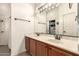Well-lit bathroom features double sinks, a large mirror, and a closet at 9260 E Greenway St, Mesa, AZ 85207