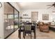 Dining area with table and chairs leading into the living room and outdoor space at 9260 E Greenway St, Mesa, AZ 85207
