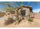 The home is surrounded by desert landscaping and a privacy wall at 9260 E Greenway St, Mesa, AZ 85207
