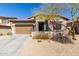 Charming single-story home with a desert-landscaped front yard and a two-car garage at 9260 E Greenway St, Mesa, AZ 85207