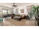Open living room featuring wood-look tile flooring, modern decor, and lots of natural light at 9260 E Greenway St, Mesa, AZ 85207