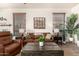 Comfortable living room with leather furniture, neutral decor, and a cozy atmosphere at 9260 E Greenway St, Mesa, AZ 85207