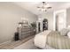 Bright main bedroom featuring a dresser with decor, ceiling fan, and entry to the walk-in closet at 9260 E Greenway St, Mesa, AZ 85207