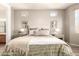 Comfortable main bedroom featuring a neutral color palette, decorative wall art, and tiled floor at 9260 E Greenway St, Mesa, AZ 85207