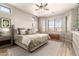 Serene main bedroom featuring a large window, cozy bedding, and stylish furnishings at 9260 E Greenway St, Mesa, AZ 85207