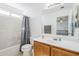 Bright bathroom featuring a shower-tub combo, a white vanity, and a large mirror at 9405 W Palmer Dr, Peoria, AZ 85345