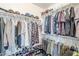 Walk-in closet featuring ample hanging space and shelving for clothes, shoes, and accessories at 9405 W Palmer Dr, Peoria, AZ 85345