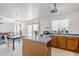 Spacious kitchen with an island, stainless steel sink, a microwave, wood cabinets, and natural light at 9405 W Palmer Dr, Peoria, AZ 85345