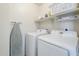 Functional laundry room featuring a Samsung washer and dryer, plus shelving for storage at 9405 W Palmer Dr, Peoria, AZ 85345