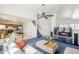 Open-concept living room with modern furniture and blue carpet at 9405 W Palmer Dr, Peoria, AZ 85345