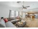 Open-concept living room with wood floors, grey couch, and vaulted ceilings at 9405 W Palmer Dr, Peoria, AZ 85345