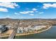 Scenic aerial view of a lakeside community featuring modern white buildings against a backdrop of mountains and blue sky at 945 E Playa Del Norte Dr # 5005, Tempe, AZ 85288