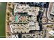 Aerial view of the apartment complex highlighting roof details, swimming pool, courtyard, landscaping, and roundabout at 945 E Playa Del Norte Dr # 5005, Tempe, AZ 85288
