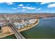 Expansive aerial view of lakeside condos, complete with bridge access, green landscaping, and waterfront views at 945 E Playa Del Norte Dr # 5005, Tempe, AZ 85288