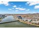 Overhead aerial of apartment complex with waterfront views, a bridge, and mountains against a blue sky with clouds at 945 E Playa Del Norte Dr # 5005, Tempe, AZ 85288