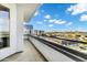 A balcony with glass railings and a view of a city and mountain range at 945 E Playa Del Norte Dr # 5005, Tempe, AZ 85288