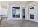 A covered balcony with white walls and sliding glass doors, providing a view of the outdoors at 945 E Playa Del Norte Dr # 5005, Tempe, AZ 85288
