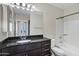 Bathroom featuring dark granite countertop, a sink, toilet and a shower-tub combo with white tiling at 945 E Playa Del Norte Dr # 5005, Tempe, AZ 85288