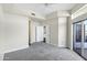 Spacious bedroom with neutral carpet, ceiling fan, and sliding glass doors to balcony at 945 E Playa Del Norte Dr # 5005, Tempe, AZ 85288