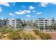 Contemporary apartment complex showcases outdoor pool and lush landscaping on a bright, cloud-filled day at 945 E Playa Del Norte Dr # 5005, Tempe, AZ 85288