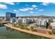 Modern apartment complex near a riverwalk with pool and landscaping, set against a backdrop of a desert mountain range at 945 E Playa Del Norte Dr # 5005, Tempe, AZ 85288