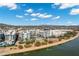 Apartment complex with view of pool and waterfront landscaping against the backdrop of desert mountains on a partly cloudy day at 945 E Playa Del Norte Dr # 5005, Tempe, AZ 85288